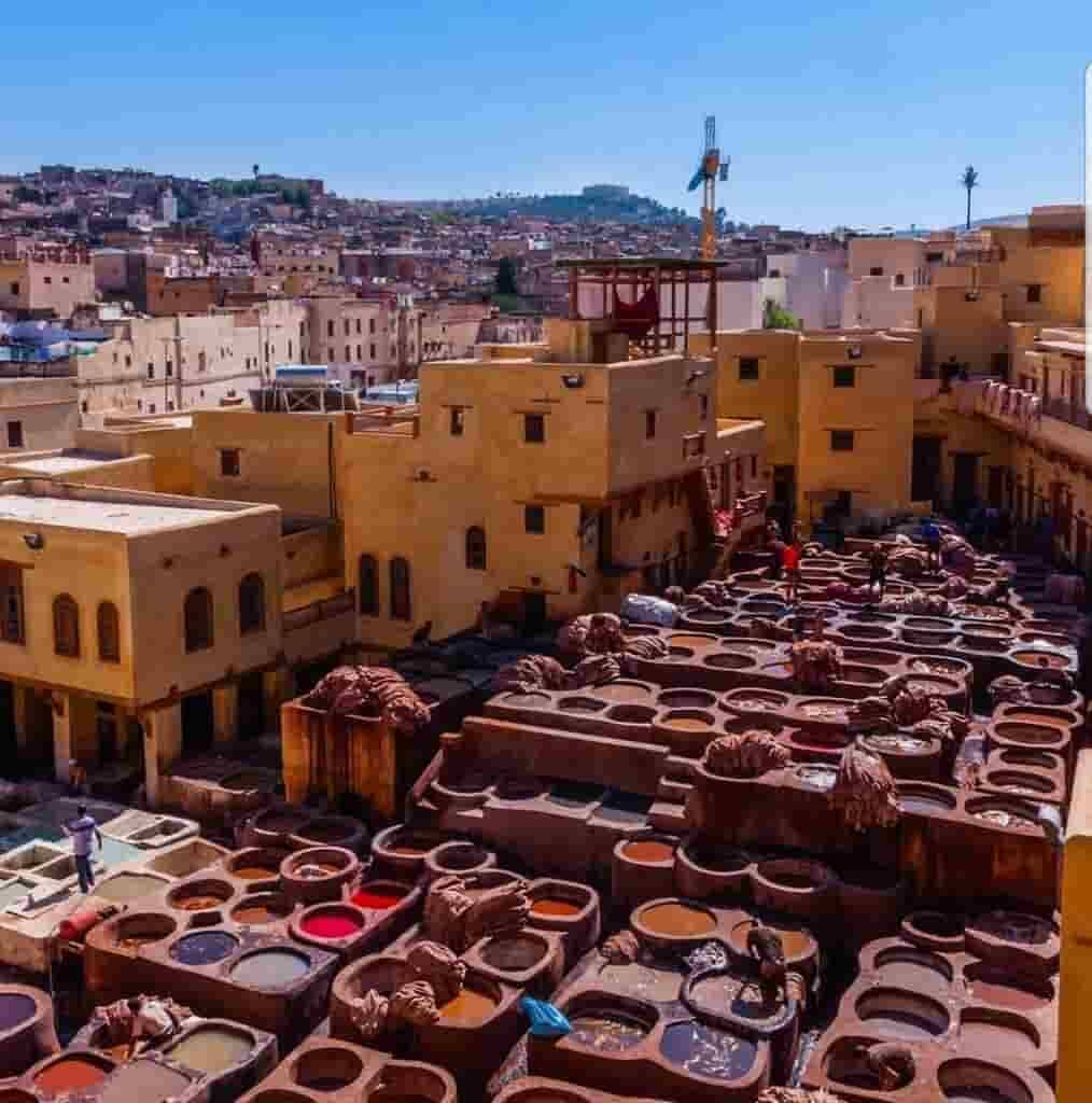 The bustling Fes Medina, where tanning vats brim with an array of vivid colors.